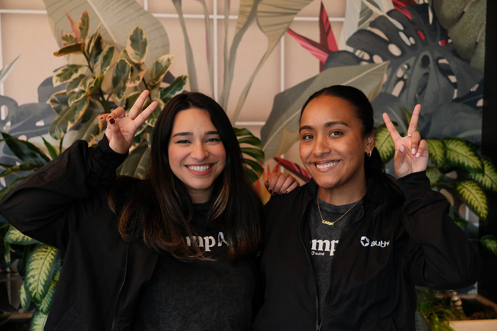 Calah Vargas and a teammate smiling in Camp AI and Auth0 jackets